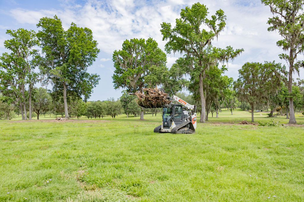 Land clearing equipment preparing a rural property for pole barn construction by Southern Pro Pole Barns & Buildings